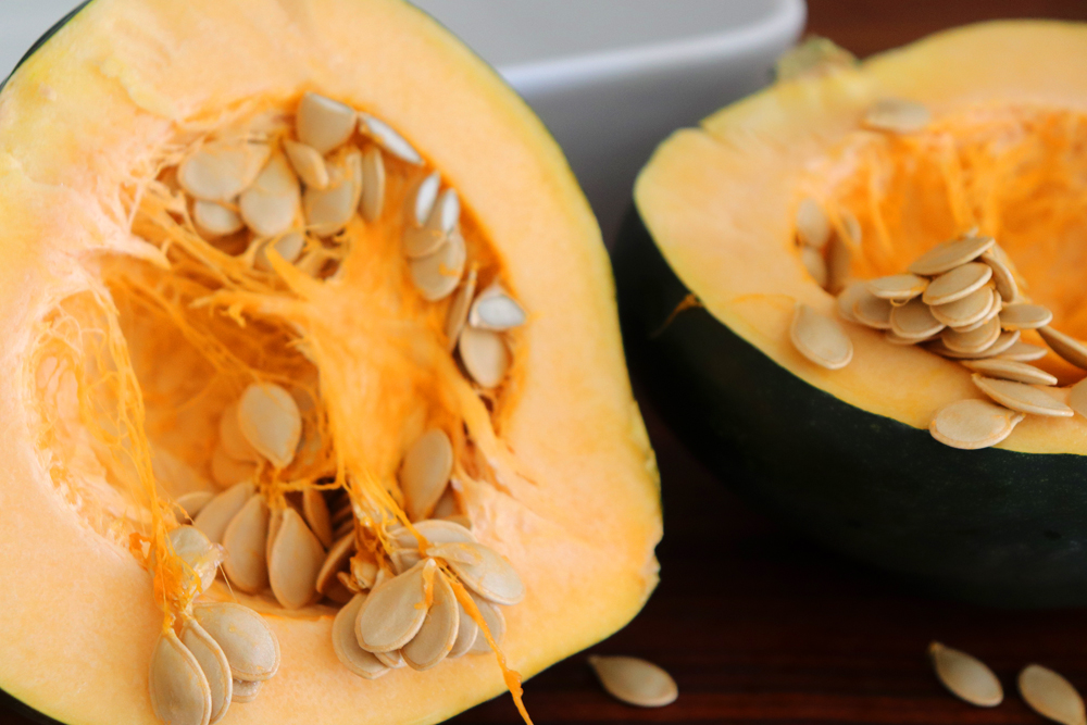 Halved acorn squash with seeds