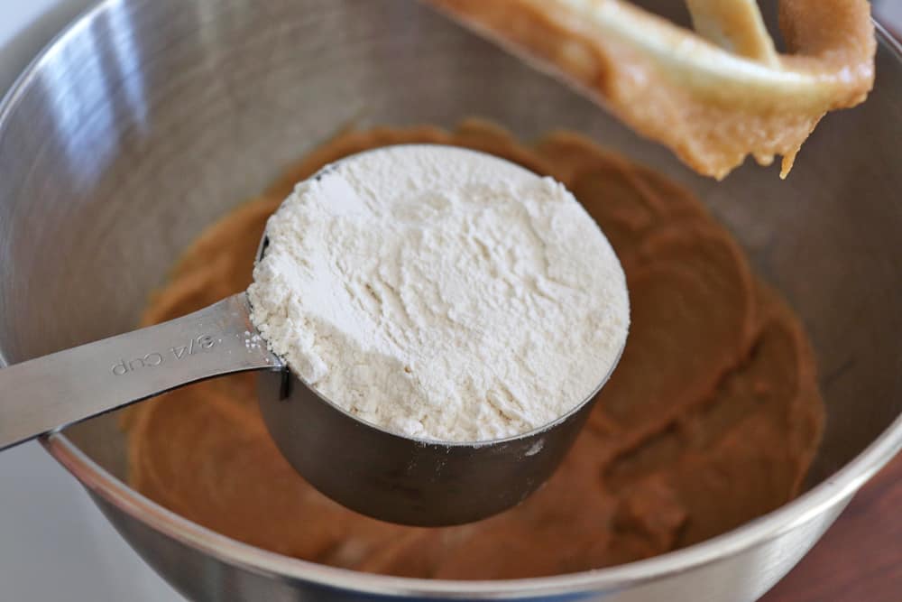 Adding flour to the peanut butter mixture for Heart Shaped Vegan Peanut Butter Cookies