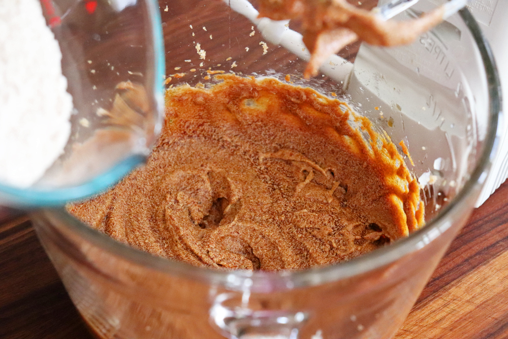 Adding flour to the gingerbread batter