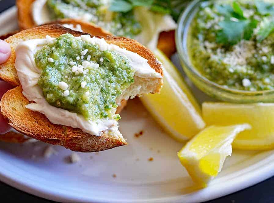 bite taken from Classic Basil Pesto & Vegan Cream Cheese Crostini
