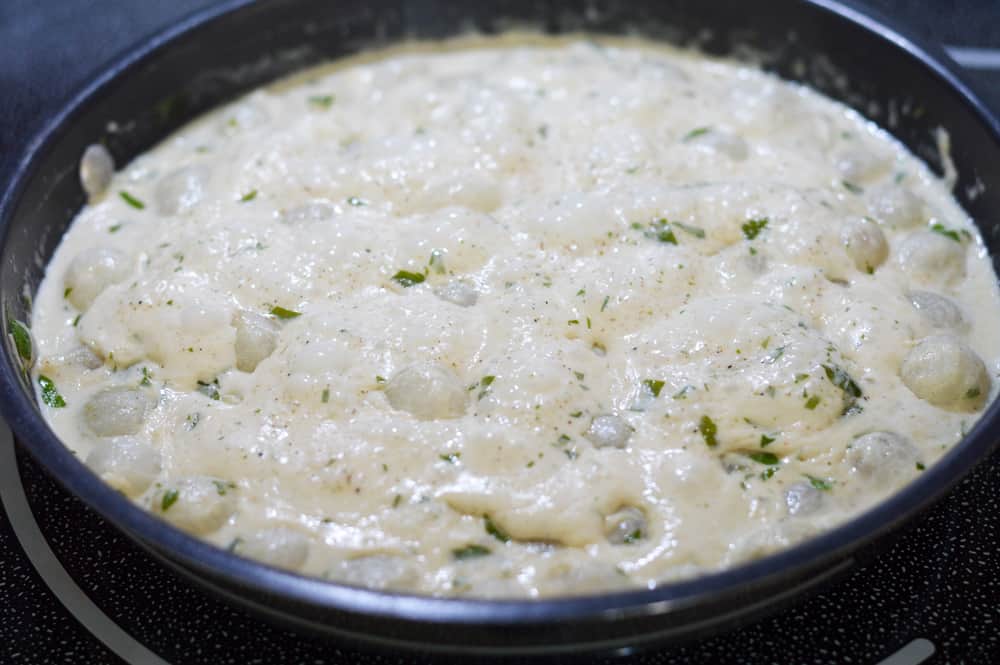 Bringing pearl onions and cream to a boil