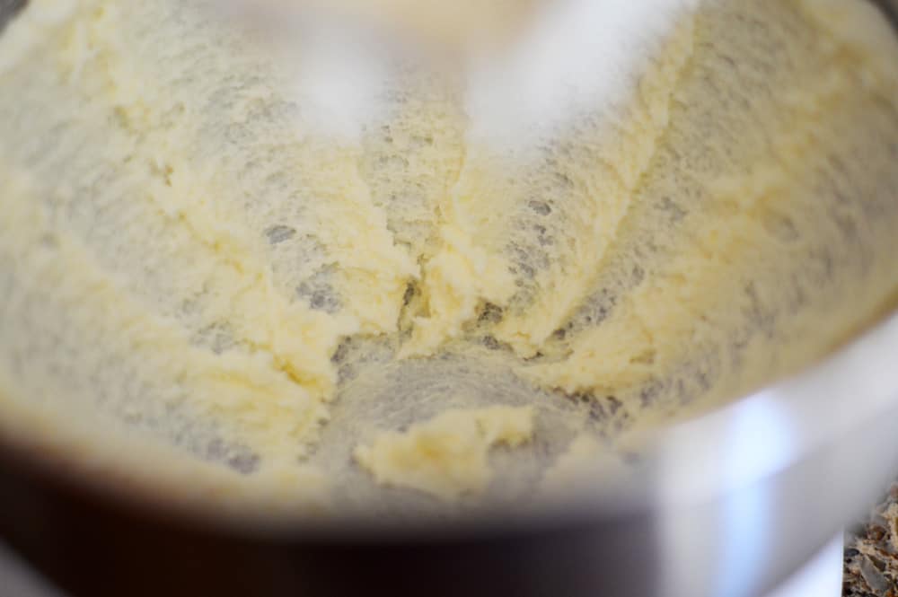 Creaming together butter and sugar in a stainless mixing bowl