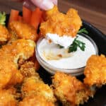 Dipping buffalo cauliflower into ranch dip