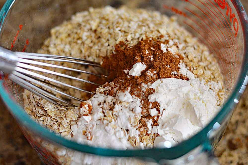 Whisking together the dry ingredients for Big & Chewy Vegan Oatmeal Raisin Cookies