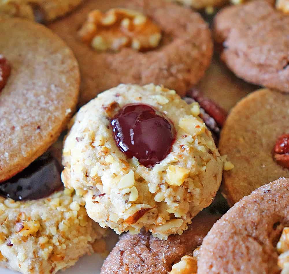 Filling the thumbprint cookies with jam
