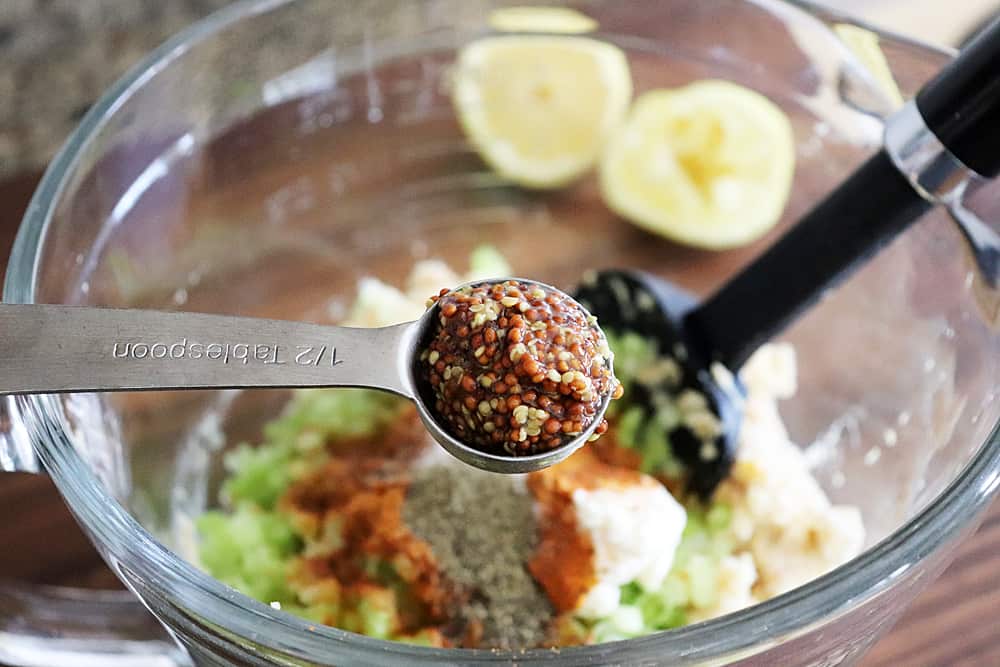 Adding grainy mustard to the mixture