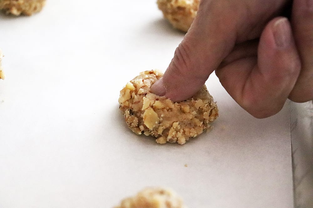 Making thumb impressions into the dough balls