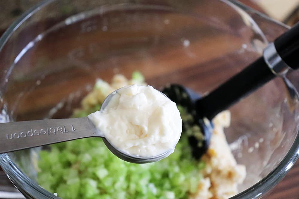 Adding mayonnaise to hearts of palm mixture
