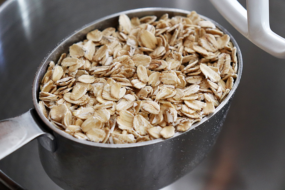 Adding oats to a mixer bowl