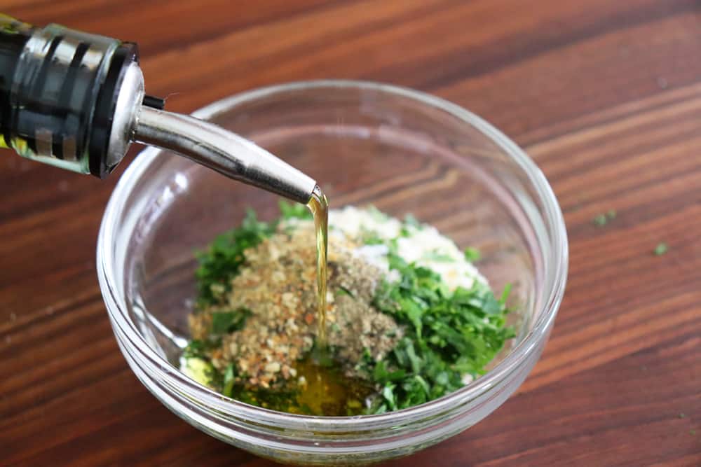 Adding oil to breadcrumb mixture