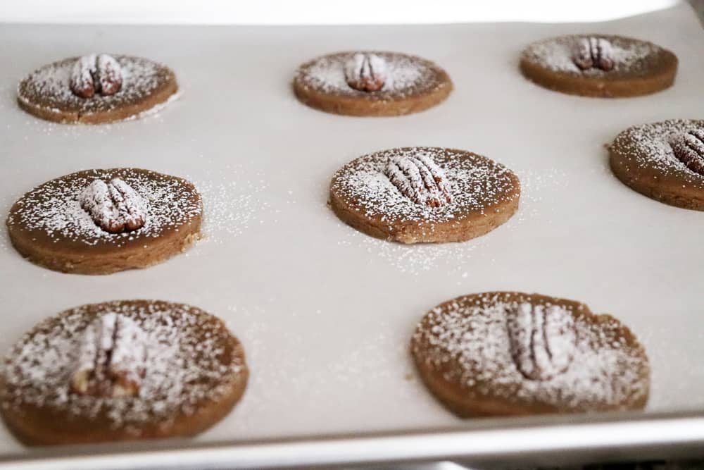 Dusted pecan sandies ready to bake on a cookie sheet