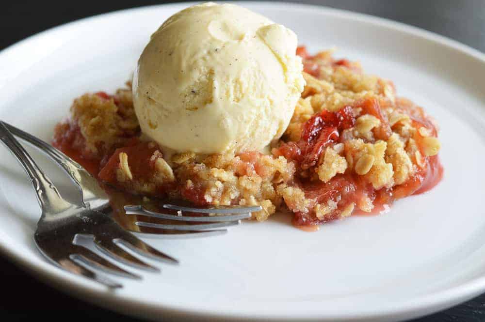 Vegan Strawberry Rhubarb Crisp Recipe on a white plate with fork