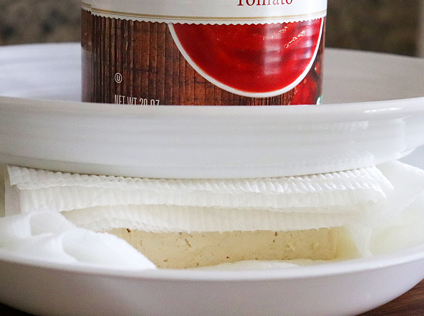 Pressing tofu between two plates