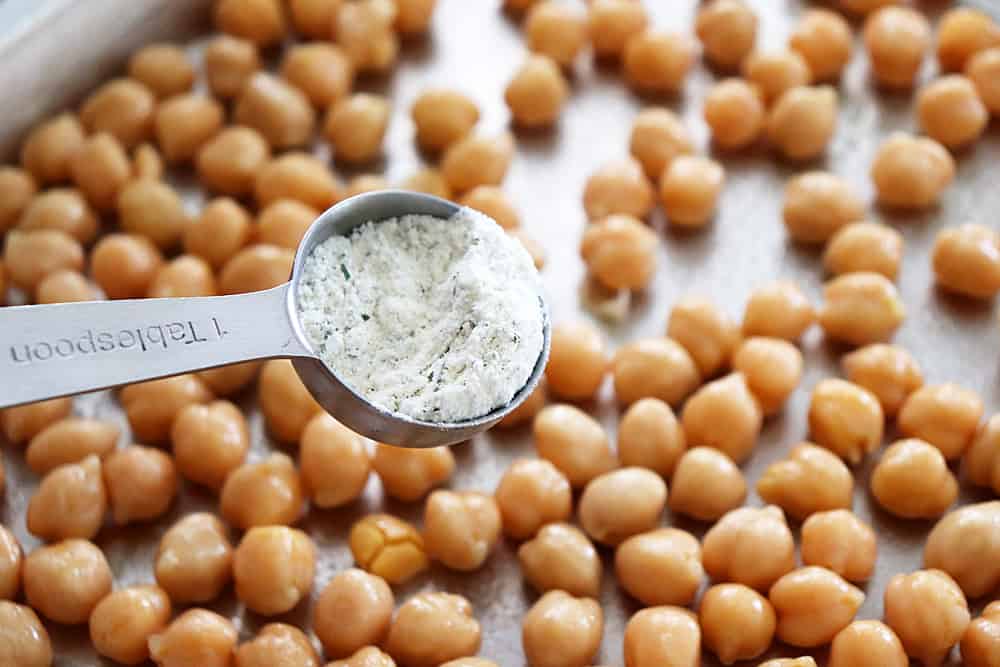 Sprinkling ranch seasoning on the chickpeas