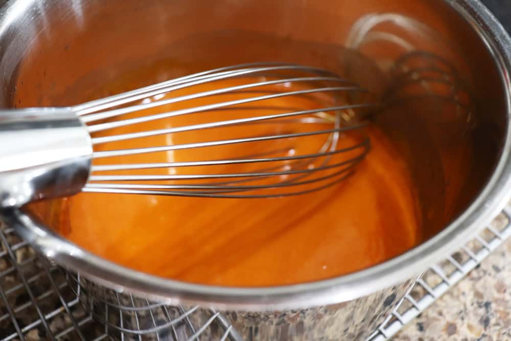 Whisk in buffalo hot sauce