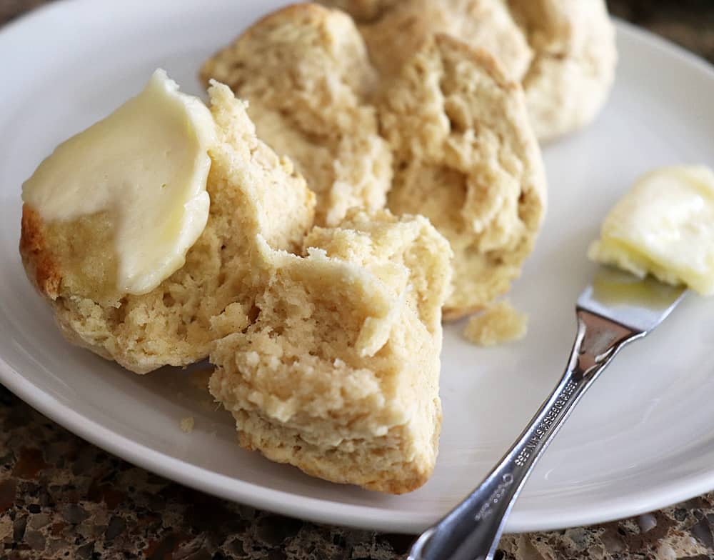 Spreading vegan margarine on irish soda bread