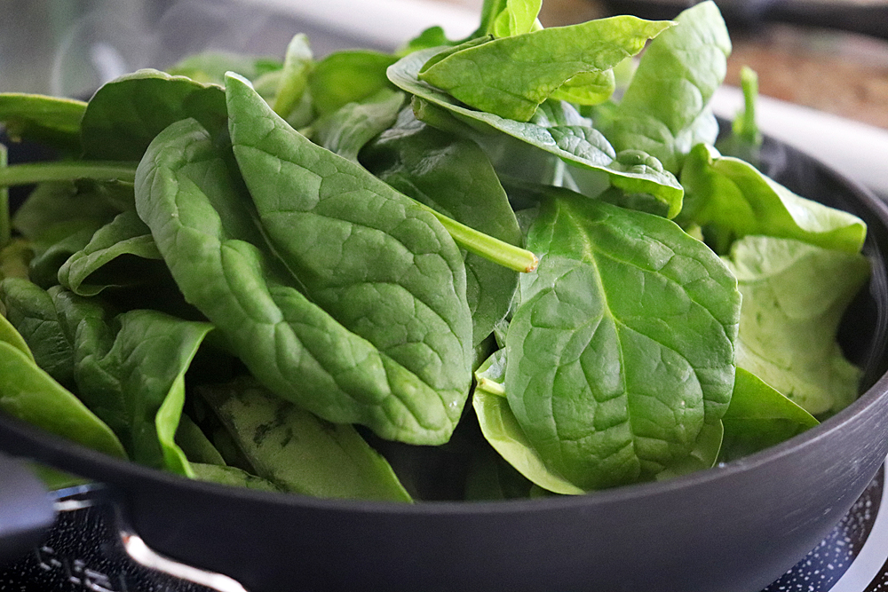 Adding spinach to the saute pan