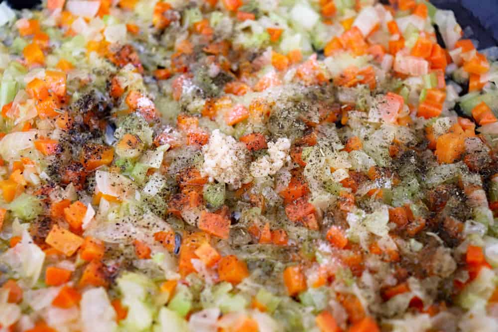Adding seasonings to the sauteeing vegetables