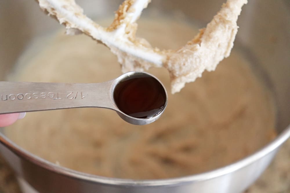 Vanilla extract being added to the electric mixer