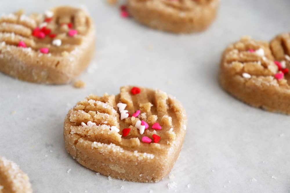 Adding red, white and pink vegan sprinkles to the Vegan Peanut Butter Cookies before baking