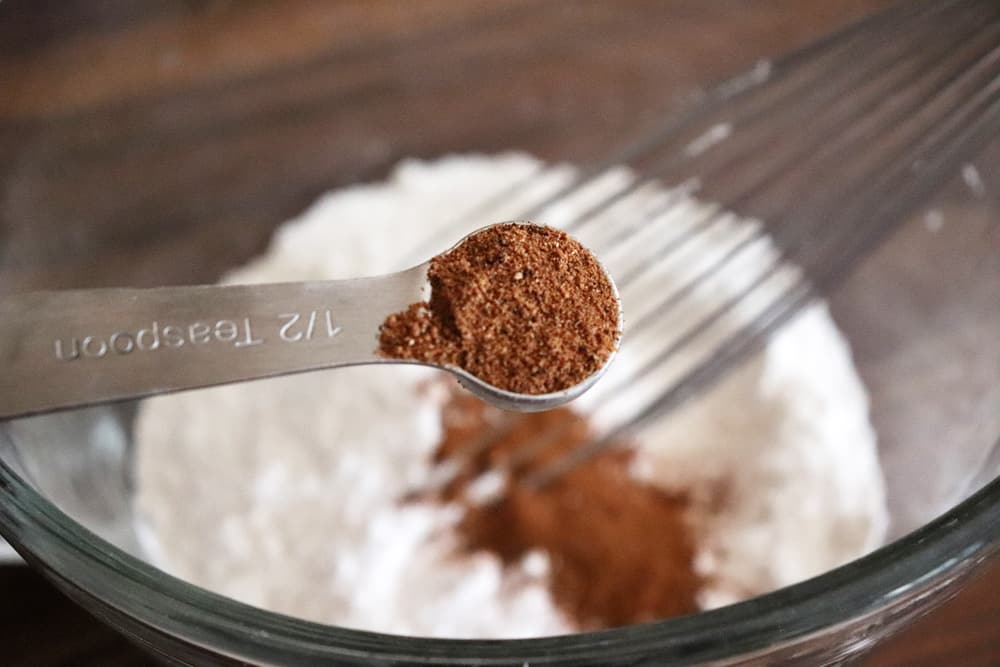 Adding nutmeg to the flour mixture