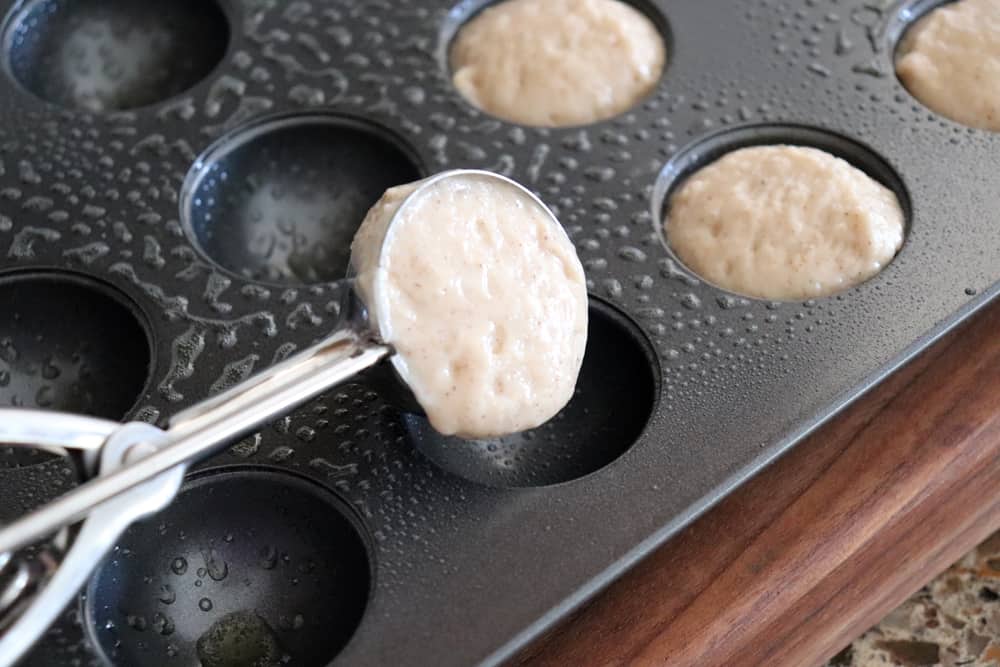 Scooping batter into doughnut pan