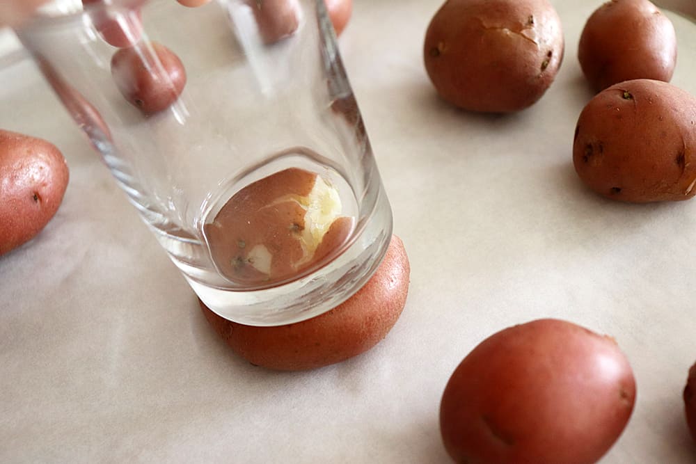 Using a glass to smash potatoes