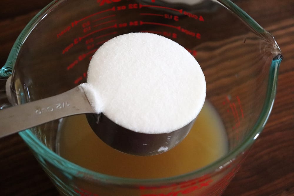 Adding sugar to the apple cider mixture